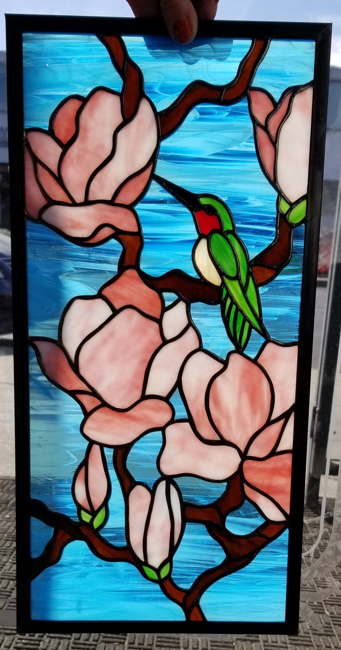 Custom stained glass hummingbird and magnolia window panel