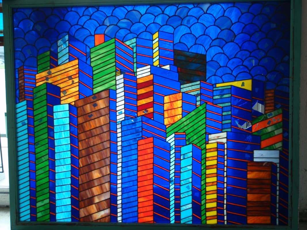 Detail of broken stained glass cityscape awaiting repair